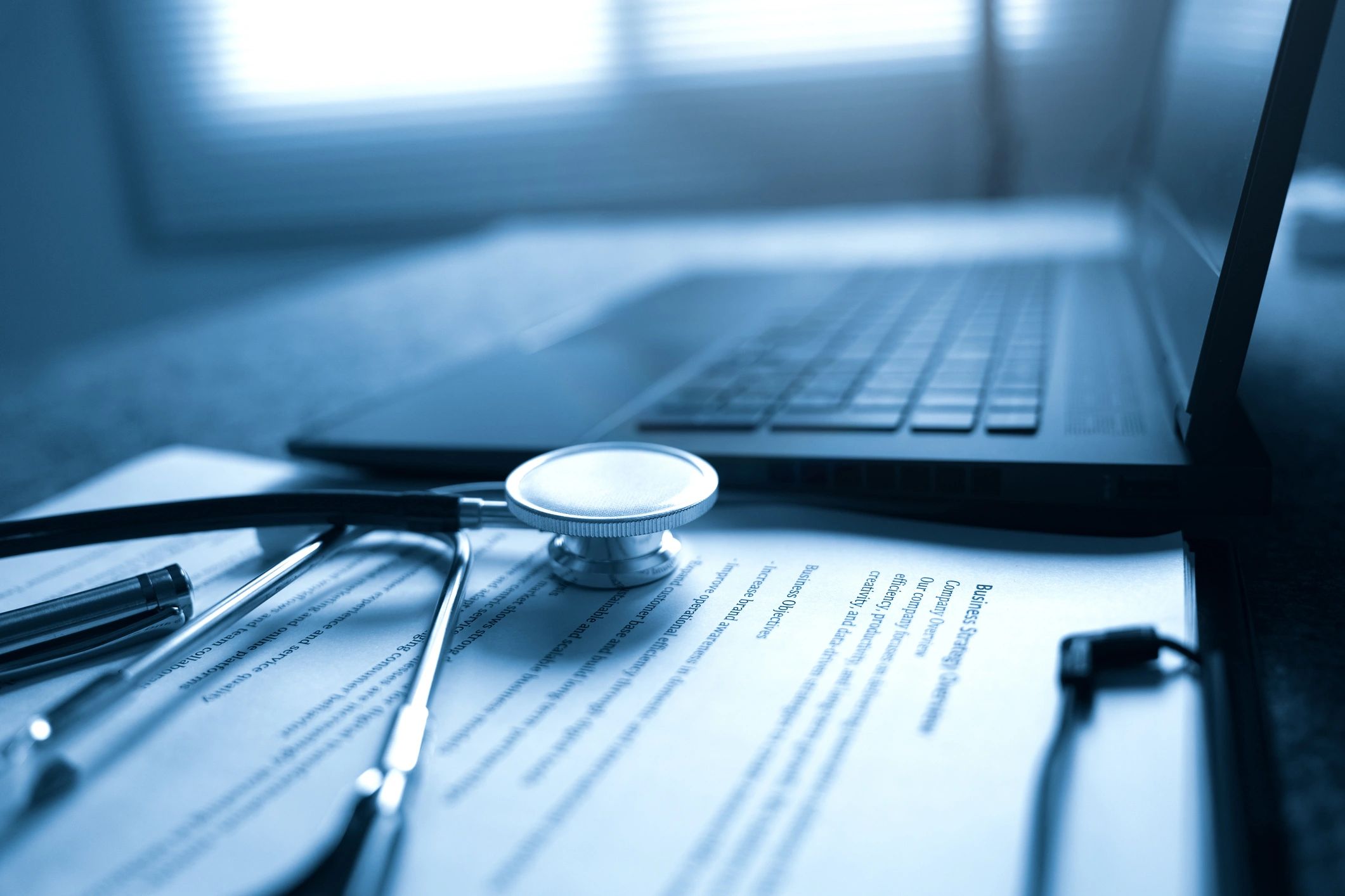 Professional medical workspace with laptop and stethoscope