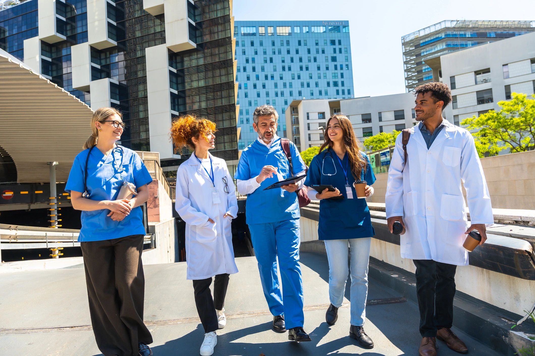 Medical team walking together and discussing collaboration